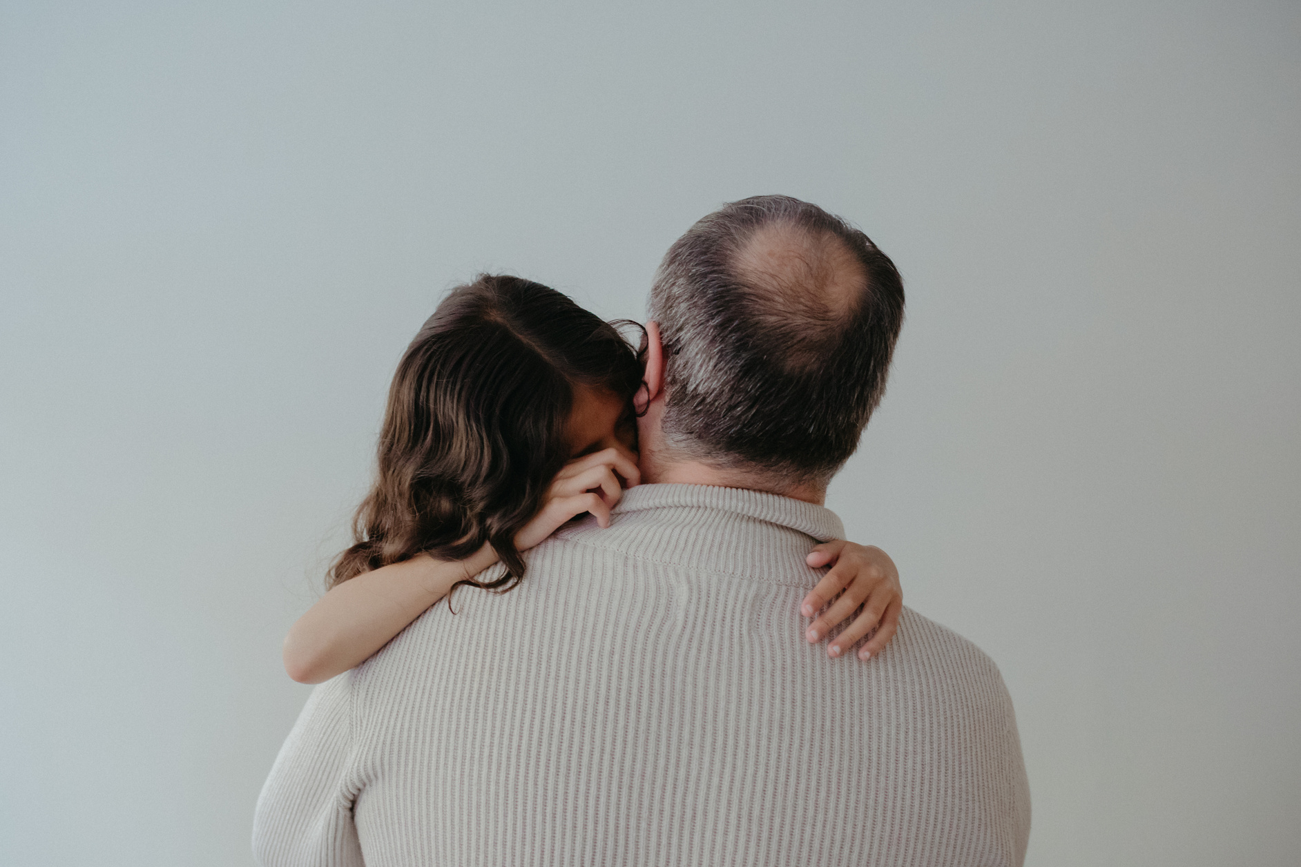 an older person hugging a young child