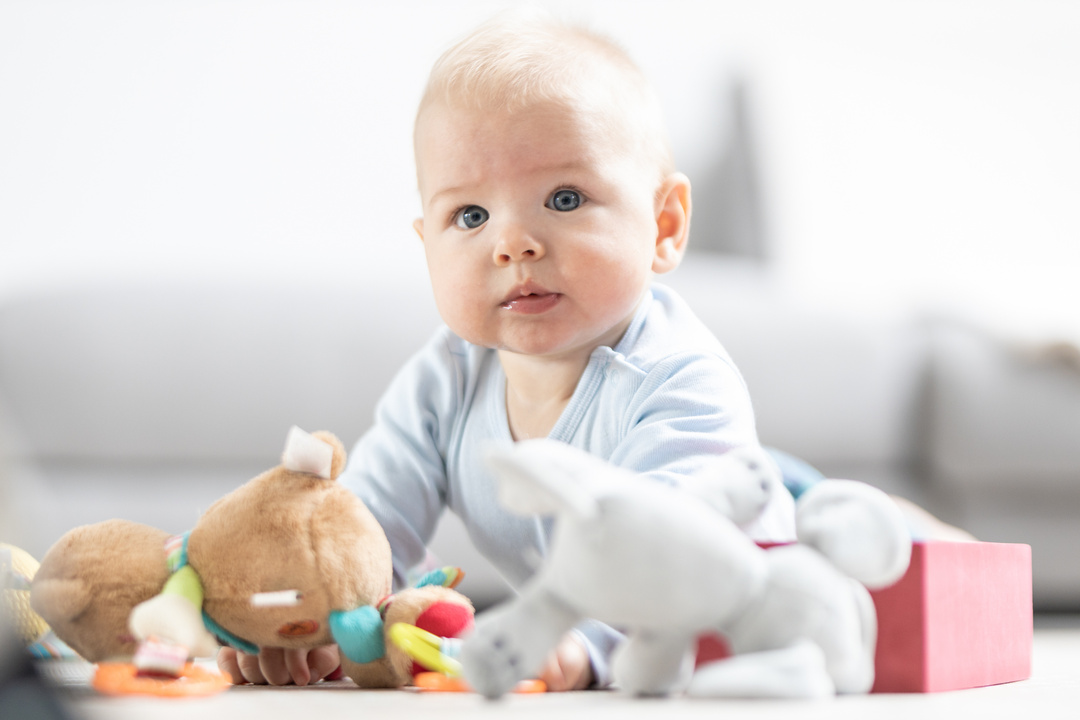 Cute Baby Boy Playing with Toys on Mat at Home Baby Activity and Play Center for Early Infant Development. Baby Playing at Home.